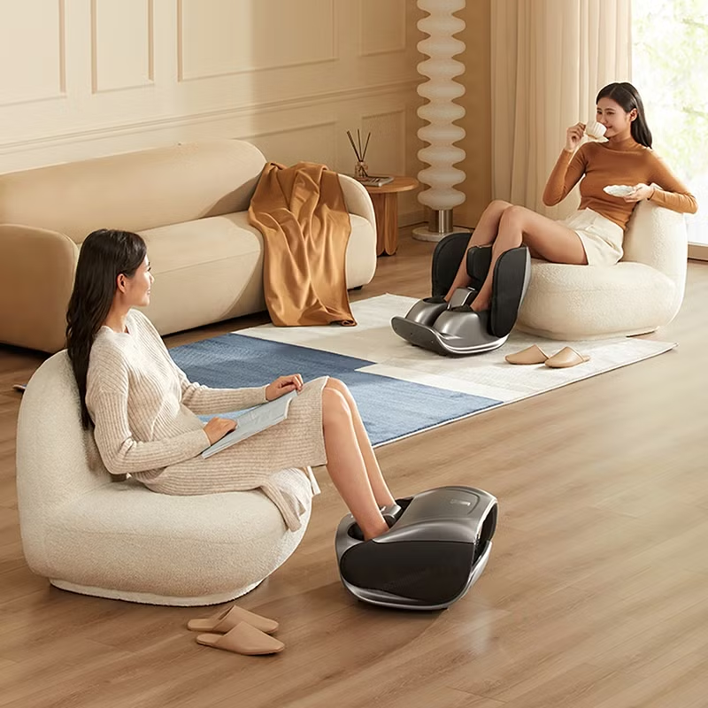 Person relaxing at home using an electric foot massager with heat function for stress relief.